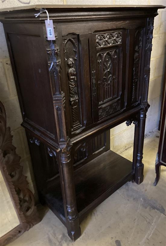 A medieval style oak cabinet on stand, width 90cm, depth 44cm, height 140cm